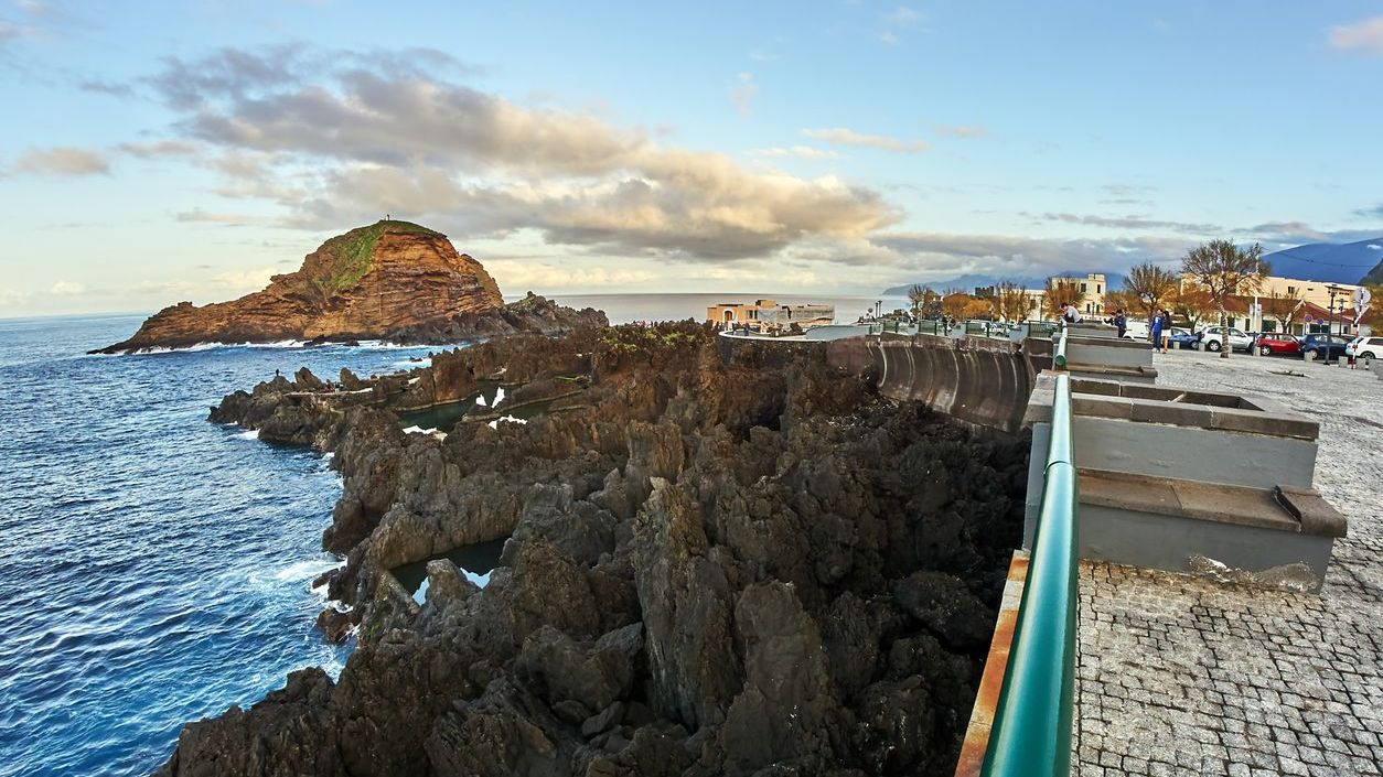 Wood Porto Moniz, Portugal - December 26, 2018: Pedestrians walk along the rocky coast of Porto Moniz on Madeira